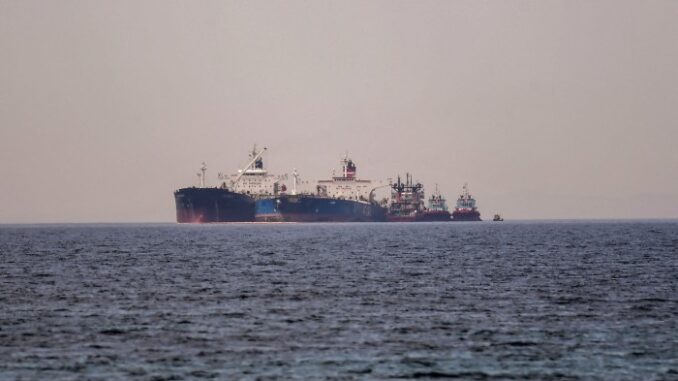 Global oil supplies forecast to outstrip demand this year despite Two large oil tankers are positioned side by side in the sea