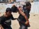 Palestinians help carry a man who was injured while waiting for aid in Rafah, in the southern Gaza Strip on June 16 2025