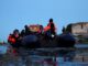 An inflatable dinghy prepares to set out into the English Channel from Ambleteuse, near Calais