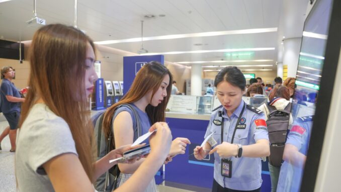 Chinese authorities are using a new tool to hack seized A border police officer answers questions from inbound passengers at Chongqing Jiangbei International Airport in southwest China's Chongqing, July 8, 2025.